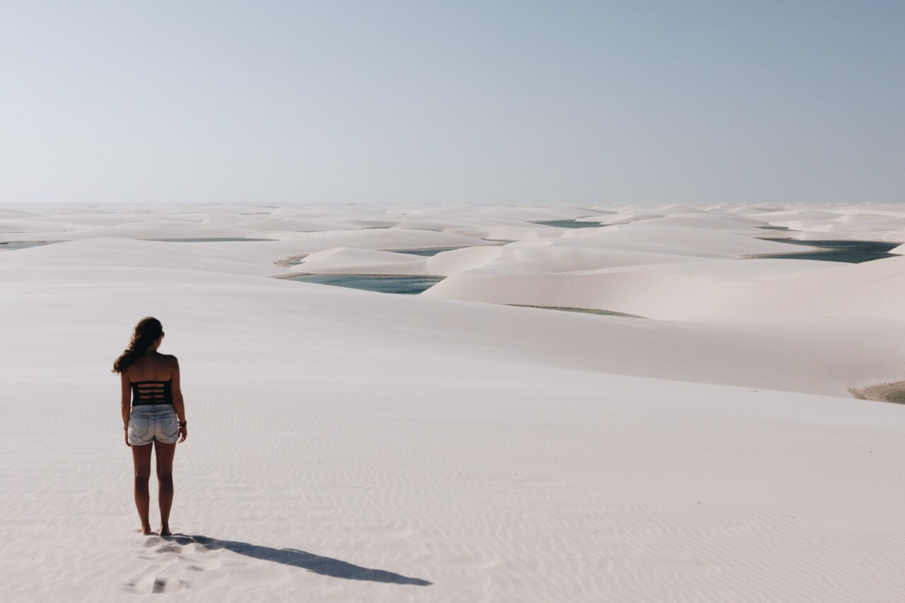 Una ragazza osserva i "lenzuoli" del Parque Nacional dos Lençóis Maranhenses, in Brasile.